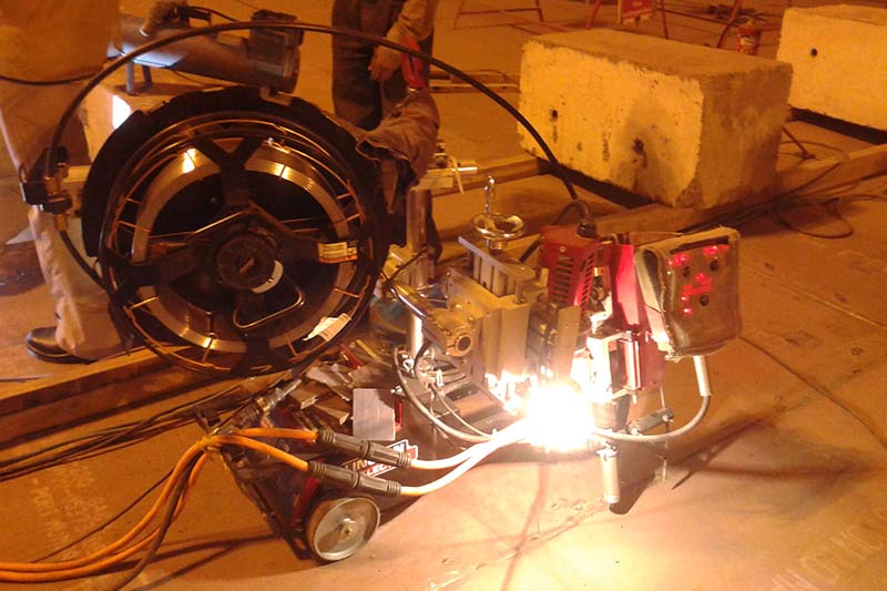 Automatic welding of tank bottom plates using four wheeled submerged arc automatic welding tractor